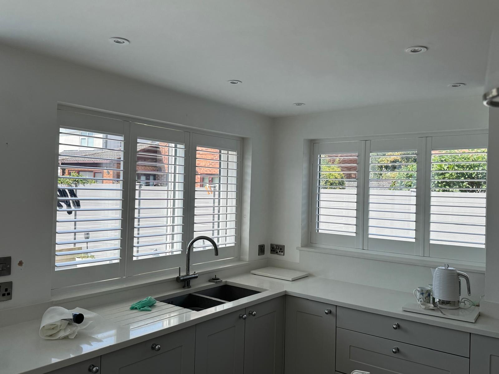 Made-to-measure white shutters fitted in a modern kitchen